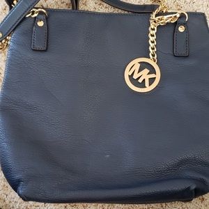 Michael Kor’s navy handbag. No stains or damage to the lining